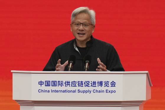 Nvidia CEO Jensen Huang gestures as he speaks on stage during the opening ceremony of the third China International Supply Chain Expo, in Beijing on July 16. [AP/YONHAP]