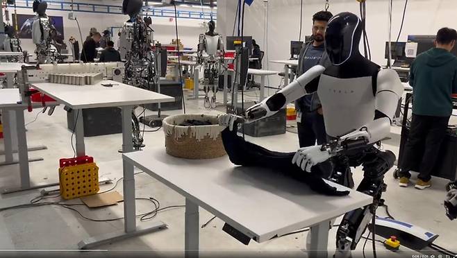 테슬라가 개발 중인 휴머노이드 로봇 ‘옵티머스’가 자연스럽게 옷을 개는 영상이 공개됐다. [테슬라]