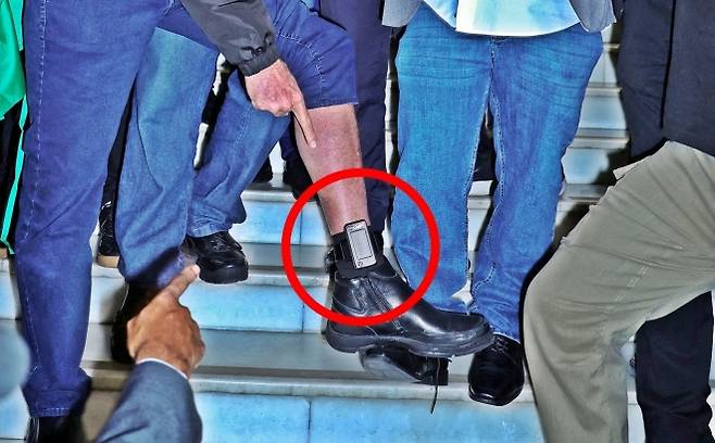 ‘남미의 트럼프’로 불리는 자이르 보우소나루 전 브라질 대통령이 21일(현지시간) 브라질 수도 브라질리아에 있는 국회의사당(연방 상·하원) 건물 앞에서 발목에 달린 전자발찌를 기자들에게 보여주고 있다. 2025.7.21 브라질리아 로이터 연합뉴스