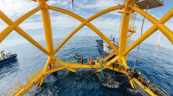 칭저우 해상풍력발전기에 설치된 양식장에서 어민들이 물고기를 끌어올리고 있다. 이 양식장 용량은 5000㎥로 연간 7만 5000㎏의 어류를 길러 낸다. 밍양 제공