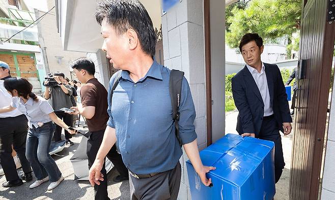 12·3 비상계엄 사태 관련 내란·외환 사건을 수사하는 내란 특별검사팀이 24일 서울 종로구 한덕수 전 국무총리 자택에서 압수수색을 마친 뒤 압수품을 들고 나오고 있다. 뉴스1