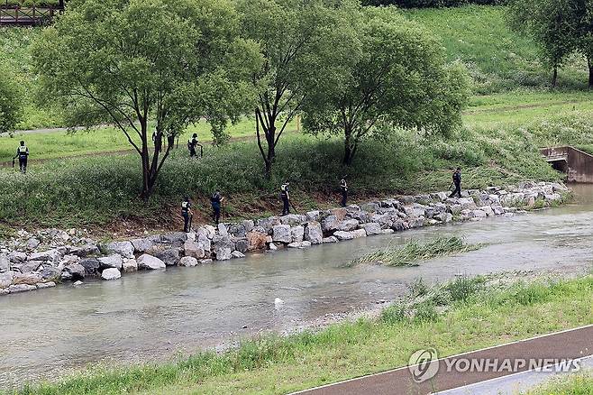 물에 휩쓸린 실종자 수색작업 중인 경찰 (세종=연합뉴스) 양영석 기자 = 18일 오후 세종시 나성동 제천에서 경찰이 물에 휩쓸려 실종된 40대 남성을 수색하고 있다. 2025.7.18 swan@yna.co.kr