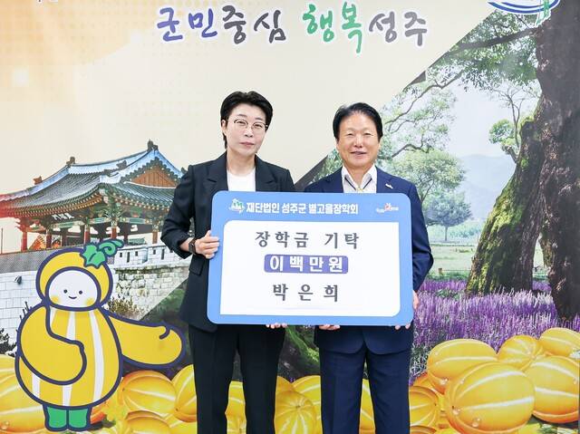 박은희 성주군청 여자태권도선수단 감독이 지난 2025 WT 월드컵팀챔피언십 시리즈 대회에서 1위를 차지해 받은 포상금 200만 원을 성주군 인재육성을 위해 별고을장학회 이병환이사장에게 전달하고 있다,