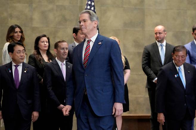 U.S. Treasury Secretary Scott Bessent walks to a meeting room with Japanese Prime Minister Shigeru Ishiba and Japanese Economic Revitalization Minister Ryosei Akazawa before their meeting at the prime minister's office in Tokyo on July 18. [REUTERS/YONHAP]
