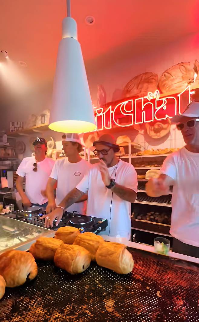 A DJ spins records in place of baking bread during a "bakery rave" held at a bakery in Belgium in 2024./TikTok