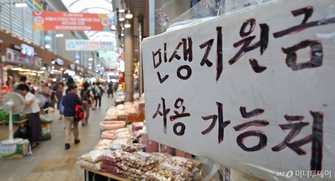 (서울=뉴스1) 장수영 기자 = 25일 오후 서울 동대문구 청량리종합시장에 민생회복 소비쿠폰 사용가능 점포 안내문이 붙어 있다.   정부에 따르면 전 국민에게 최대 1인당 45만 원을 지급하는 민생회복 소비쿠폰 신청자가 나흘 만에 2890만 명을 돌파한 것으로 집계됐다.   전체 지급 대상자(5060만여 명) 가운데 57.1%가 신청했으며, 총 지급액은 5조 2186억 원에 이른다. 2025.7.25/뉴스1  Copyright (C) 뉴스1. All rights reserved. 무단 전재 및 재배포,  AI학습 이용 금지. /사진=(서울=뉴스1) 장수영 기자