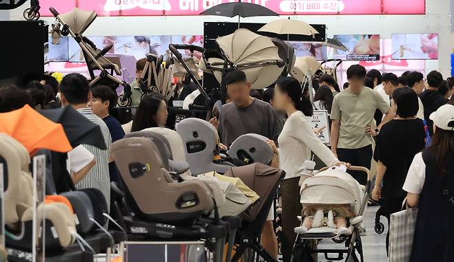 지난 6월 19일 서울 강서구 코엑스마곡 컨벤션센터에서 열린 ‘2025 맘스홀릭베이비페어’에서 관람객들이 육아용품을 살펴보고 있다. [연합]