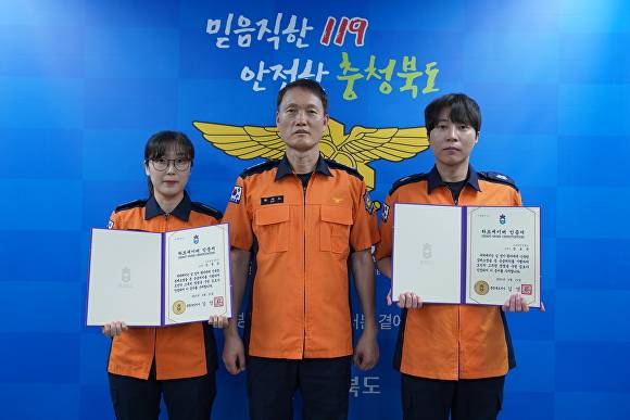 류지노(가운데) 충북119종합상황실장이 29일 심정지 환자의 생명을 구한 김명선(왼쪽) 소방장과 장보규 소방사에게 하트세이버 인증서를 수여한 뒤 기념 사진을 찍고 있다. [사진=충북소방본부]