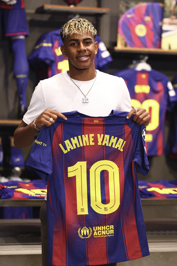 라민 야말이 지난 7월 16일(현지시간) 바르셀로나와 계약을 연장한 뒤 배번 10번이 적힌 자신의 새로운 유니폼을 들어보이고 있다. 로이터