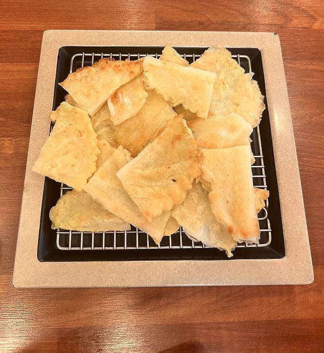 Sliced napa cabbage pancake, also known as baechujeon, served at Halmeoni Mung Bean Pancake in Mapo-gu, western Seoul (Park Jun-hee/The Korea Herald)