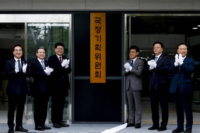 ▲ 이한주 국정기획위원회 위원장과 김용범 대통령실 정책실장, 더불어민주당 진성준 정책위의장 등 참석자들이 지난달 16일 서울 종로구 정부서울청사 창성동 별관에서 열린 국정기획위 현판식에서 손뼉 치고 있다. 연합뉴스
