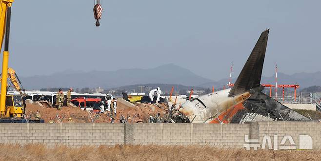 [무안=뉴시스] 김선웅 기자 = 2일 전남 무안국제공항 제주항공 여객기 참사 현장에서 항공·철도사고 조사위원회(ARAIB) 관계자들이 로컬라이저(방위각 표시 시설)가 설치된 콘크리트 둔덕을 조사하고 있다.  2025.01.02. mangusta@newsis.com