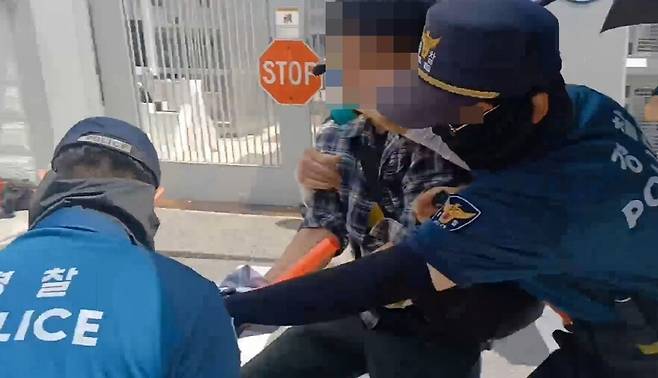 한국대학생진보연합(대진연) 회원 1명이 5일 오후 1시쯤 서울 종로구 주한 미국대사관 앞에서 기습시위를 벌이다 경찰관들에 의해 제지당하고 있다. ⓒ대진연 페이스북 캡처