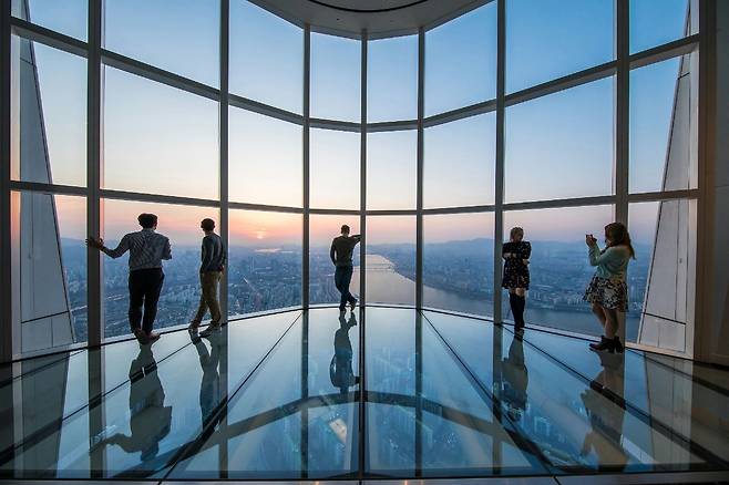 외국인들이 롯데월드타워 초고층 전망대에서 기념사진을 찍고 있다. 롯데물산 제공