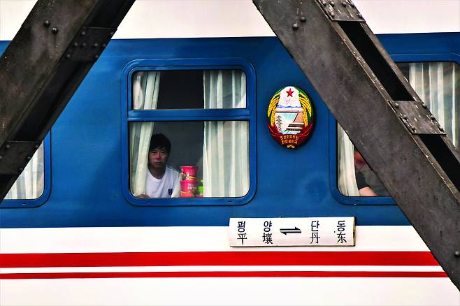 A person is seen on a train connecting Pyongyang in North Korea and Dandong in China in an undated photo. [JOONGANG ILBO]