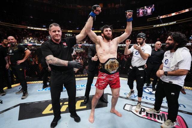 페레이라를 꺾고 UFC 라이트급헤비급 챔피언에 오른 안칼라예프(가운데 빨간 트렁크)가 벨트를 차고 환호하고 있다. /UFC 제공