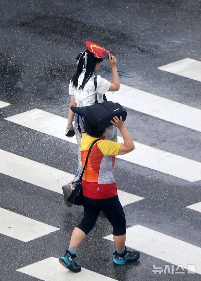 [서울=뉴시스] 홍효식 기자 = 소나기가 내린 8일 서울 중구 을지로1가 사거리에서 시민들이 발걸음을 재촉하고 있다. 2025.08.08. yesphoto@newsis.com