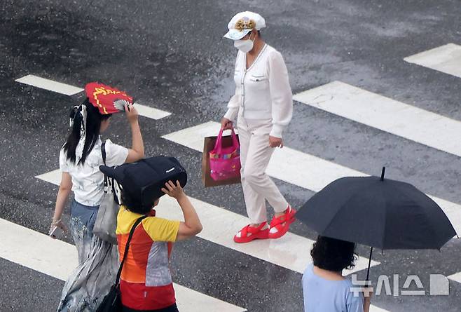 [서울=뉴시스] 홍효식 기자 = 소나기가 내린 8일 서울 중구 을지로1가 사거리에서 시민들이 발걸음을 재촉하고 있다. 2025.08.08. yesphoto@newsis.com
