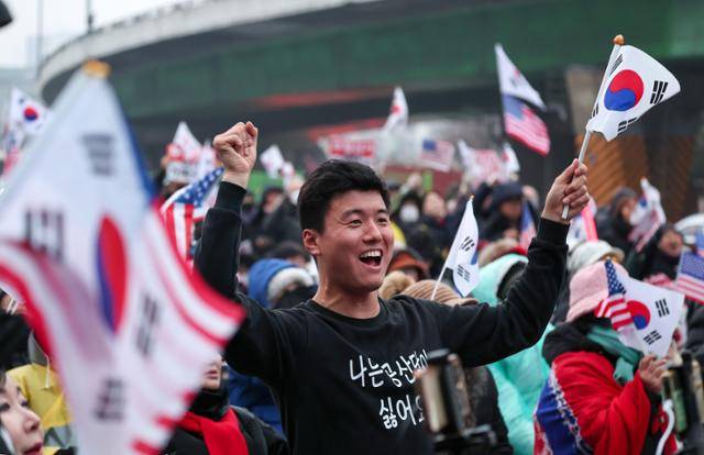 1월 6일 서울 용산구 한남동 대통령 관저 인근에서 윤석열 대통령 지지자들이 공수처의 체포영장 집행 관련 경찰 일임 기사를 접한 후 환호하고 있다. 뉴스1