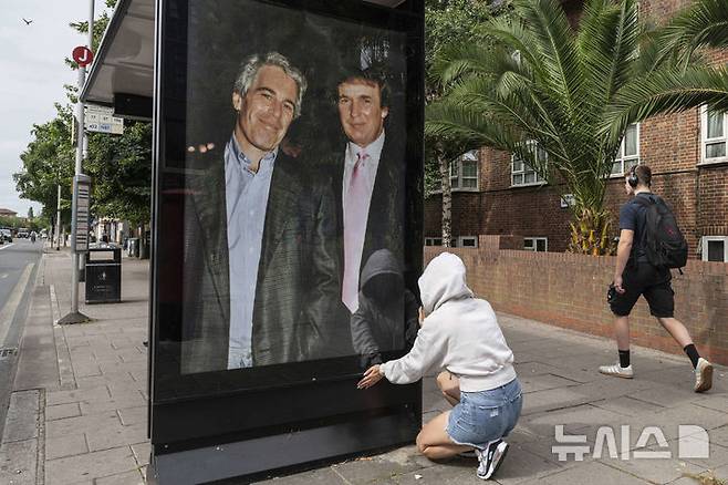 [런던=AP/뉴시스]영국의 한 활동가가 자살한 성매매 재벌 제프리 엡스타인(왼쪽)과 젊은 시절의 도널드 트럼프 미 대통령이 함께 찍은 사진을 런던 거리에 걸고 있다. 트럼프가 7일 밤(현지시각) 자신의 관세 정책을 비판하는 사설을 줄곧 실어온 월스트리트저널(WSJ)의 논설위원실이 중국 중심적이라고 비난했다. 2025.7.18.