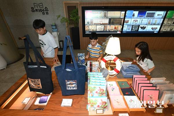 12일 용인시 기흥구 경기도박물관에서 시민들이 머그컵, 손수건, 파우치 등 다양한 굿즈 상품을 살펴보고 있다. 2025.8.12 /최은성기자 ces7198@kyeongin.com