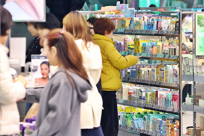 People shop at an Olive Young store in Seoul on March 12. [YONHAP]
