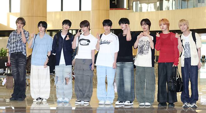 Boy band AHOF poses for photos at Gimpo International Airport in western Seoul on Aug. 8, ahead of its trip to Japan for promotional events. [NEWS1]