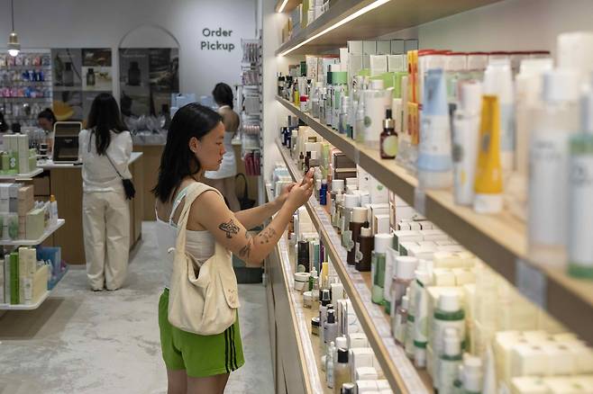 A customer checks out Asian beauty products at a Senti Senti store in New York on July 25. (AP/YONHAP)