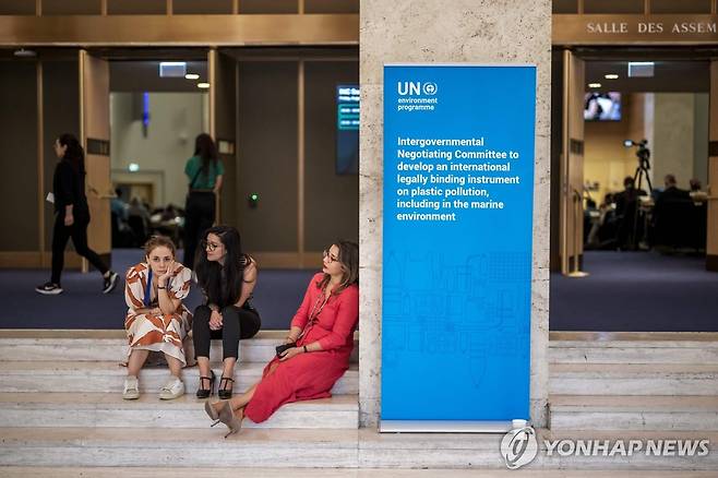 15일(현지시간) 스위스 제네바 플라스틱 오염 종식을 위한 국제협약 성안을 위한 제5차 정부 간 협상위 추가 협상 회의가 진행되는 회의장 밖에서 관계자들의 쉬고 있다. [AFP=연합뉴스