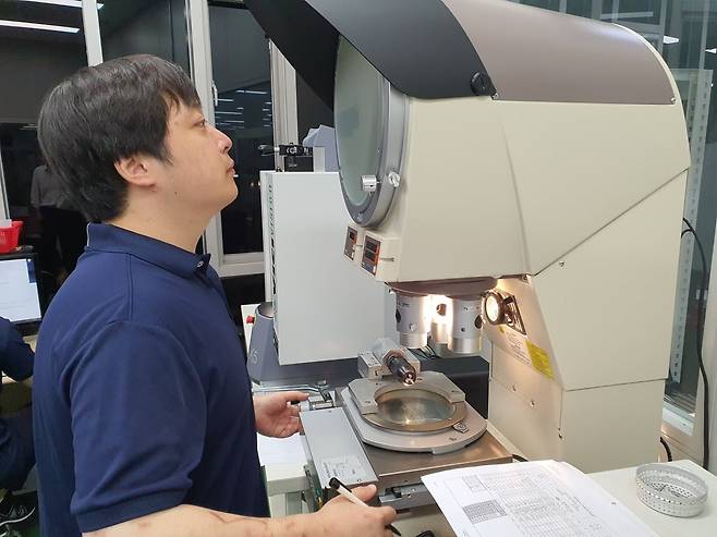 권택삼 사원이 투영기 측정을 하고 있다. 부산=윤현주 기자