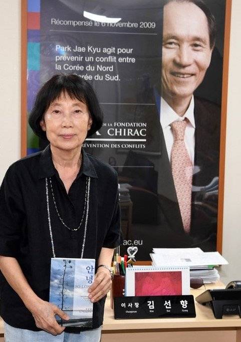 김선향 북한대학원대학교 이사장(왼쪽)이 1일 남편 박재규 경남대 총장(전 통일부장관)의 사진이 들어간 시라크재단 분쟁방지상 수상 기념 포스터 앞에서 포즈를 취했다. 북한대학원대학교 제공.