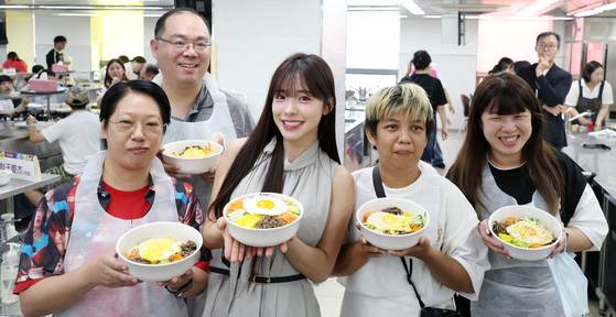 치어리더 이다혜가 18일 전북 전주시 한국전통문화전당에서 대만 팬들과 함께 비빔밥 만들기 체험을 하고 기념촬영을 하고 있다. 전북 출신 이다혜 치어리더는 오늘 완주 대승한지마을에서 전북특별자치도 관광홍보대사로 위촉된다. [뉴스1]