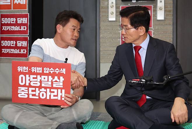 전한길 씨가 18일 오후 서울 여의도 국민의힘 중앙당사를 찾아 특검의 국민의힘 압수수색 저지 농성 중인 김문수 당대표 후보와 만나 악수하고 있다. 전 씨는 이 자리에서 장동혁 후보 지지와 관련된 보도에 대해 오해라는 입장을 밝혔다. 뉴스1