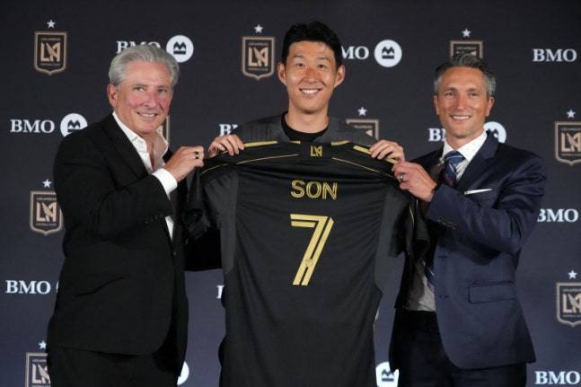 손흥민(가운데)이 LAFC 구단주 베넷 로젠탈(왼쪽)과 존 소링턴 단장과 함께 포즈를 취하고 있다. 로이터=연합뉴스