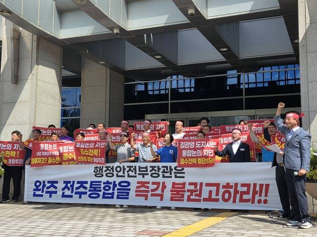 27일 전북특별자치도청 앞에서 완주 전주 통합 반대 완주군민대책위가 기자회견을 열고 기념사진을 촬영하고 있다./사진=이준서 기자