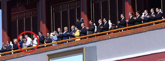 World leaders watch a military parade at Tiananmen Square in Beijing, China, on Sept. 3, 2015, to commemorate the 70th anniversary of China's Victory Day. Nikolai Lukashenko, circled in red, the third son of Belarusian President Alexander Lukashenko, is seen on the ramparts. [JOINT PRESS CORPS]