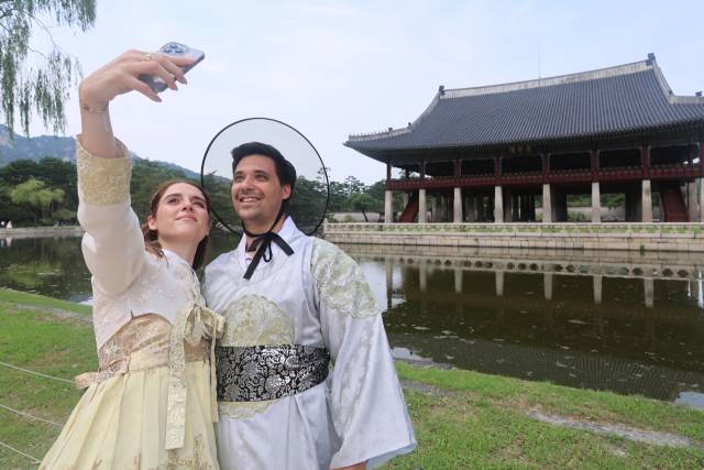 8월 31일 서울 경복궁에서 한복을 입은 외국인 관광객 커플이 경회루를 배경으로 기념사진을 찍고 있다. 연합뉴스