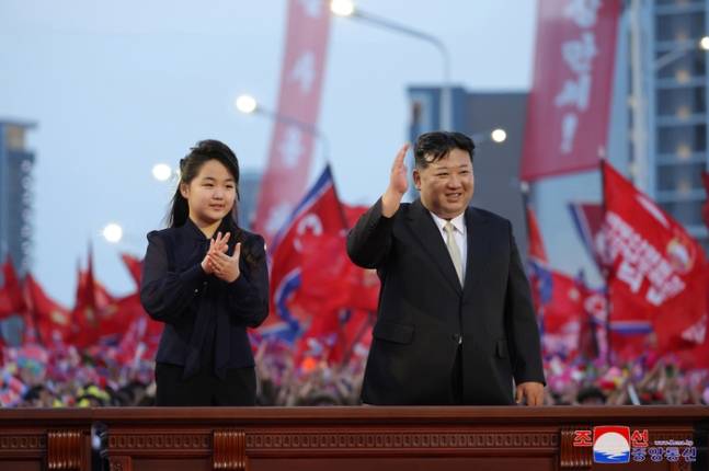 North Korean leader Kim Jong-un, right, and his daughter Kim Ju-ae greet residents at the completion ceremony for Jeonwi Street, a new neighborhood in northern Pyongyang, on May 14, 2024. [YONHAP]