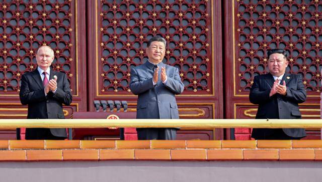 김정은(오른쪽부터) 북한 국무위원장, 시진핑 중국 국가주석, 블라디미르 푸틴 러시아 대통령이 3일 중국 베이징에서 열린 '중국 인민 항일 전쟁 및 세계 반파시스트 전쟁 승리(전승절) 80주년' 열병식에 참관하고자 톈안먼 망루에 서 손뼉을 치며 보고 있다. 베이징=EPA 연합뉴스