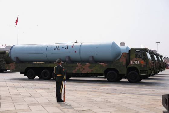 A member of the People's Liberation Army stands as the strategic strike group displays weaponry during a military parade to mark the 80th anniversary of the end of the Sino-Japanese War in Beijing, China, Sept. 3. [REUTERS/YONHAP]