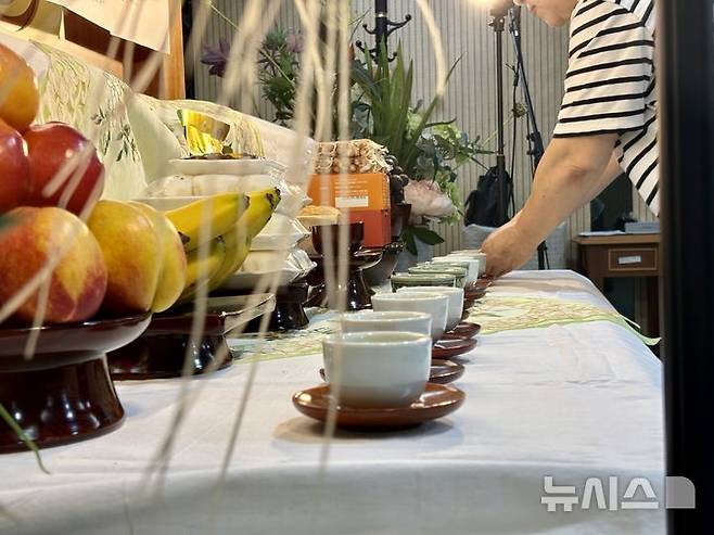 [서울=뉴시스] 한이재 기자 = 지난달 13일 서울 중구 국립중앙의료원에서 열린 무연고 사망자를 위한 시민 추모식에 참가한 시민이 제사상에 차를 올리고 있다. 2025.09.05. nowone@newsis.com