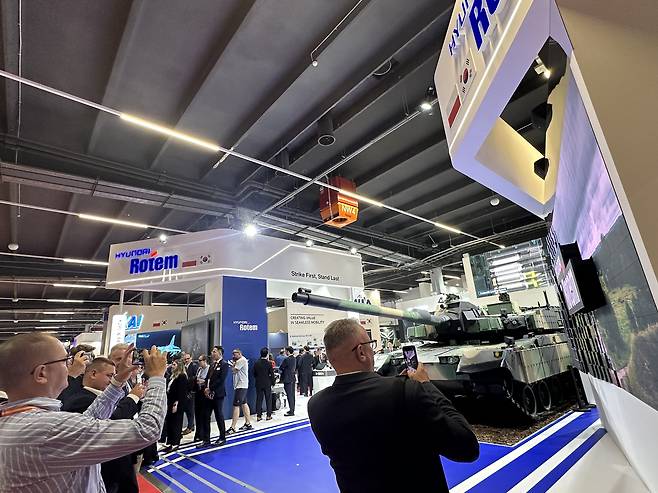 Visitors take photos of Hyundai Rotem’s K2 tank on display at MSPO 2025 in Kielce, Poland, on Sept. 2. [SEO JI-EUN]