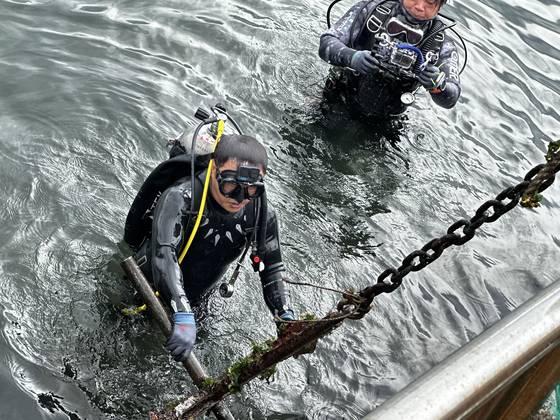 8일 오후 2시 제주시 조천읍 조천포구에서 연예인 김병만이 다이빙을 하며 쓰레기를 수거하는 플로빙을 하며 수거한 선박용 '닻'을 클레인에 고정하고 있다. 최충일 기자