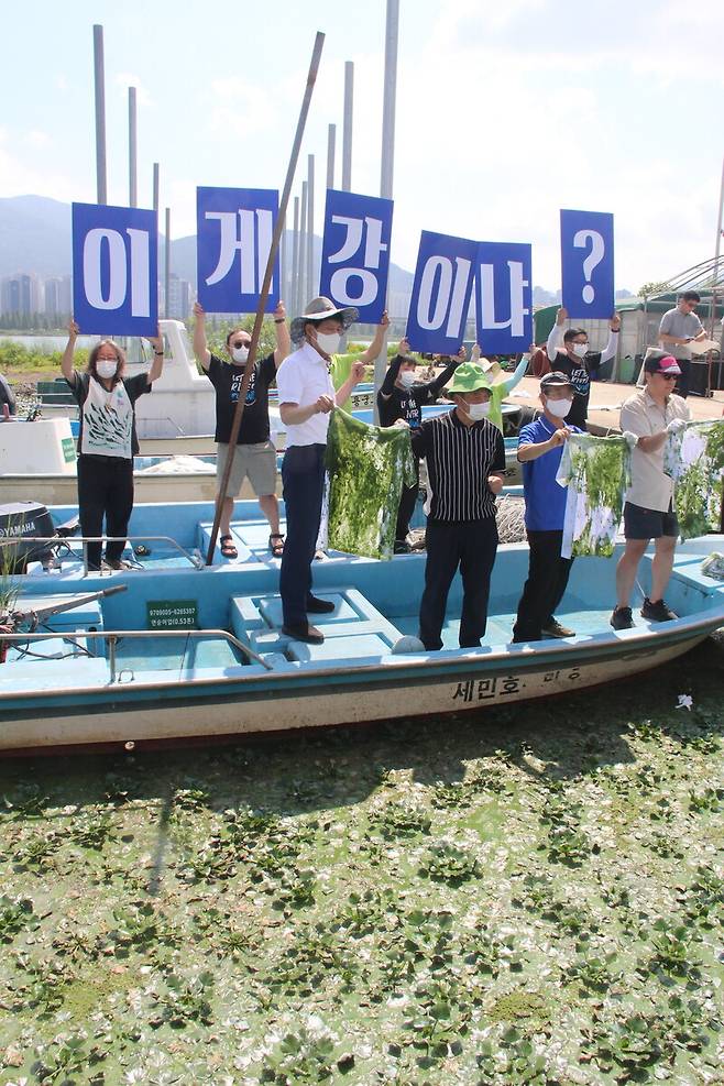 3일 환경운동가들이 녹조가 가득한 경남 김해시 대동 선착장의 배 위에서 ‘이게 강이냐?’ 피켓을 들고 있다. 김규원 선임기자