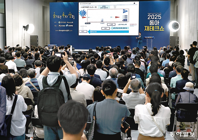 12일 서울 강남구 코엑스에서 열린 2025 동아재테크쇼를 찾은 관람객들이 재테크 전문가 강연장에서 절세, 투자 전략이 담긴 발표 자료 화면이 나오자 스마트폰을 들어 사진을 찍고 있다. 양회성 기자 yohan@donga.com