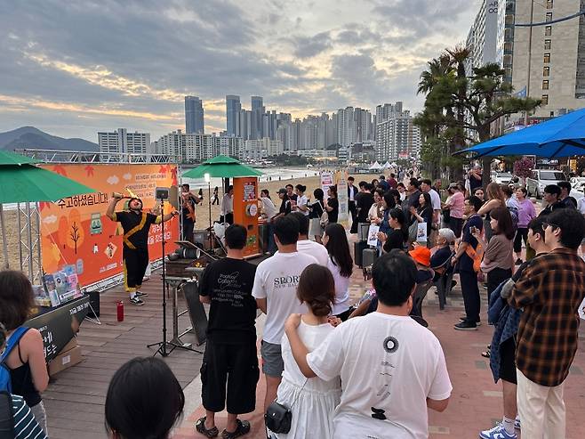 부산 광안리 해변에서 열린 제주관광 현장홍보 행사에서 시민들이 버스킹 공연을 지켜보고 있다. (제주도관광협회 제공)