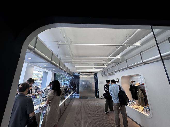 The first floor of Cafe Curious features a coffee counter and a small merchandise display near the entrance. (Moon Joon-hyun/The Korea Herald)