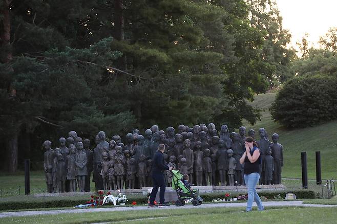 남편과 함께 유아차를 끌고 온 한 여성이 아이들 동상을 모두 살펴보지도 못한 채 돌아서서 눈물을 훔치고 있다.
