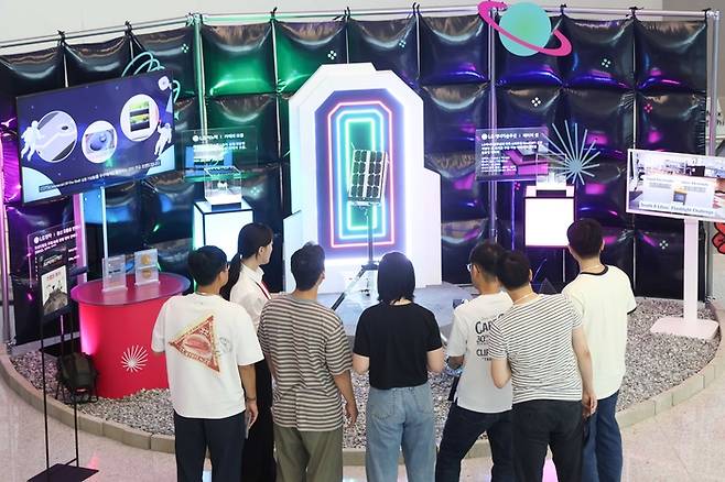 17일 서울 마곡 LG사이언스파크에서 열린 슈퍼스타트 데이 2025에서 LG 직원들이 LG의 카메라 모듈, 배터리 셀, 통신 모듈용 안테나가 탑재된 무인탐사연구소의 달 탐사 로버에 대한 설명을 듣고 있다. [사진 = LG]