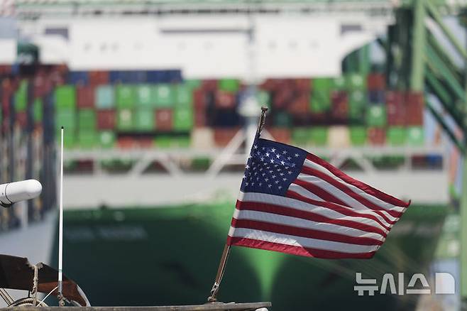 [로스앤젤레스=AP/뉴시스] 17일(현지 시간) 월스트리트저널은 두 항만이 지난달 20피트 길이의 컨데이너 단위(TEU)로 측정한 수입 컨테이너 94만4832개를 처리했는데, 이는 남부 캘리포니아 항만들이 100만 개 이상의 컨테이너를 처리하며 기록을 세웠던 7월과 비교해 6.6% 감소한 수치라고 보도했다. 사진은 미국 캘리포니아 로스앤젤레스 항구의 컨테이너선 앞에 미국 국기가 걸려 있는 모습. 2025.09.18.